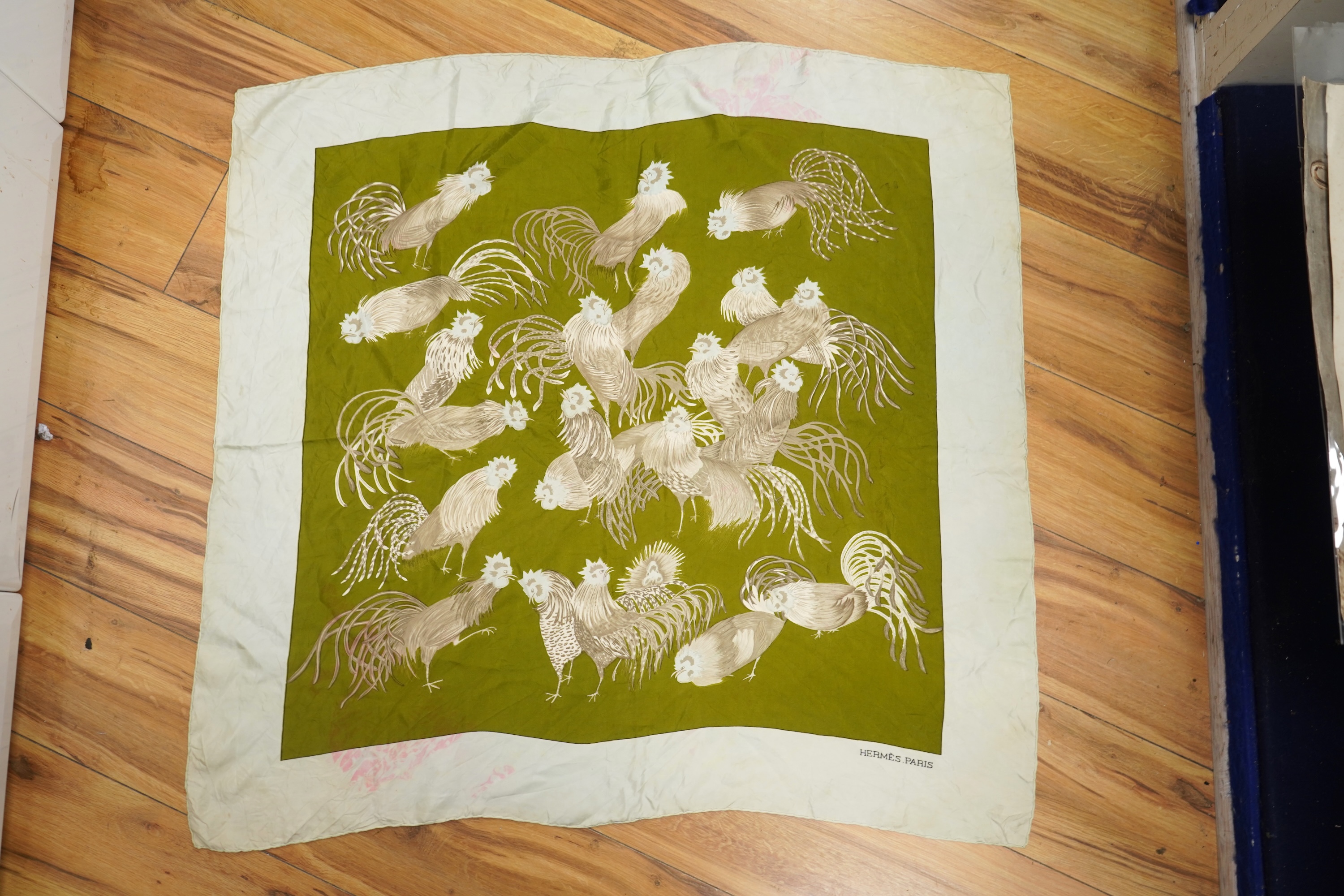 A collection of three Hermes silk scarves and a Chanel monogram example